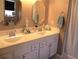 Bathroom vanity with dual sinks and storage, complemented by well-lit mirrors at 13780 Sw 111Th Ave, Dunnellon, FL 34432