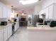 Bright kitchen with white cabinets, stainless steel appliances, and ample counter space at 13780 Sw 111Th Ave, Dunnellon, FL 34432