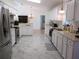 Spacious kitchen with stainless steel appliances, ample counter space, and stylish white cabinets at 13780 Sw 111Th Ave, Dunnellon, FL 34432