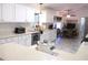 Bright kitchen with white cabinetry, stainless steel appliances, and marble tile flooring at 13780 Sw 111Th Ave, Dunnellon, FL 34432