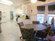 Open kitchen and dining area with white cabinets and plenty of natural light at 13780 Sw 111Th Ave, Dunnellon, FL 34432