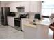 Well-lit kitchen with stainless steel appliances, bright cabinetry, and modern countertops at 13780 Sw 111Th Ave, Dunnellon, FL 34432