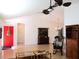 Open living room with a red front door, a ceiling fan and hardwood floors at 13780 Sw 111Th Ave, Dunnellon, FL 34432