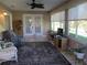 Cozy sunroom featuring a ceiling fan, tile flooring and multiple windows for natural light at 13780 Sw 111Th Ave, Dunnellon, FL 34432
