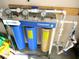 Standard whole house water filtration system with pressure gauges and three large filter canisters at 13780 Sw 111Th Ave, Dunnellon, FL 34432