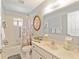 Bright bathroom with white cabinets, vanity, and a shower-tub combination, exuding a clean and simple aesthetic at 13805 Se 87Th Ter, Summerfield, FL 34491