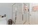 Bright bathroom featuring a glass-enclosed shower, toilet, and unique decor at 13805 Se 87Th Ter, Summerfield, FL 34491