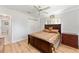 Comfortable bedroom featuring a ceiling fan, wood floors, and closet with traditional wood furniture at 13805 Se 87Th Ter, Summerfield, FL 34491