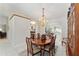 Spacious dining room featuring a china cabinet, chandelier and a large dining table for hosting gatherings at 13805 Se 87Th Ter, Summerfield, FL 34491