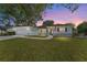 Charming single-story home with well-manicured lawn, fountain, two-car garage, and inviting walkway at 13805 Se 87Th Ter, Summerfield, FL 34491