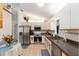 Bright kitchen features stainless steel appliances, white cabinetry, and tile flooring, blending style with functionality at 13805 Se 87Th Ter, Summerfield, FL 34491
