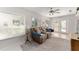 Bright living room with neutral color palette, ceiling fan, and comfortable seating at 13805 Se 87Th Ter, Summerfield, FL 34491