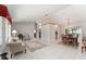 Open-concept living and dining area with tile flooring and elegant chandelier at 13805 Se 87Th Ter, Summerfield, FL 34491