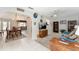 Open living area featuring a dining room, living room and neutral tile flooring, creating a cohesive and inviting space at 13805 Se 87Th Ter, Summerfield, FL 34491