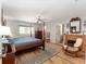 Spacious main bedroom with a ceiling fan, neutral walls, and light-colored wood-look floors at 13805 Se 87Th Ter, Summerfield, FL 34491