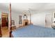 Bright main bedroom features ceiling fan, laminate wood floors, ensuite bathroom, and closet access at 13805 Se 87Th Ter, Summerfield, FL 34491