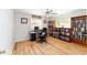 Well-lit office space with laminate wood floors, bookcases, and modern desk setup at 13805 Se 87Th Ter, Summerfield, FL 34491
