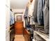 Spacious walk-in closet with organized storage, shelving, hanging rods, and built-in wooden drawers at 13805 Se 87Th Ter, Summerfield, FL 34491