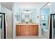 Bright bathroom featuring a double sink vanity, with tile flooring, and ample lighting at 1689 Van Buren Way, The Villages, FL 32162