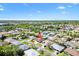 Aerial view of single story home in a well manicured neighborhood with a lake nearby at 17472 Se 112Th Ct, Summerfield, FL 34491