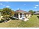Backyard with patio, seating and beautiful landscaping at 17472 Se 112Th Ct, Summerfield, FL 34491