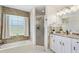 Bathroom featuring a tub, window, and mosaic tile at 17472 Se 112Th Ct, Summerfield, FL 34491