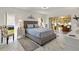 Serene bedroom with a large bed, marble floors, and sliding doors to the outdoor patio or lanai at 17472 Se 112Th Ct, Summerfield, FL 34491