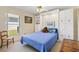 A charming bedroom with window, teddy bear, blue comforter, and overhead lights at 17472 Se 112Th Ct, Summerfield, FL 34491
