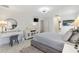 Bright bedroom with a vanity, white furniture, and a neutral color palette, creating a serene atmosphere at 17472 Se 112Th Ct, Summerfield, FL 34491