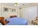 Cozy bedroom with a ceiling fan, closet, and classic decor at 17472 Se 112Th Ct, Summerfield, FL 34491