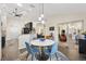 Bright dining area featuring modern table and chairs, seamlessly connected to the kitchen and living spaces at 17472 Se 112Th Ct, Summerfield, FL 34491