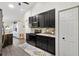 Modern kitchen with black cabinets, granite countertops, tile backsplash, and stainless steel appliances at 17472 Se 112Th Ct, Summerfield, FL 34491