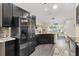 The kitchen boasts dark cabinets, granite countertops, and stainless steel appliances, offering a modern design at 17472 Se 112Th Ct, Summerfield, FL 34491