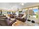 Sunroom with recliners, sofas, a patterned rug, and large windows at 17472 Se 112Th Ct, Summerfield, FL 34491
