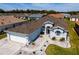 Aerial view of a light blue home with a brown shingled roof in a residential community at 1813 Sw 157Th Place Rd, Ocala, FL 34473