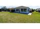 The backyard features a spacious lanai and is surrounded by well-maintained lush green grass at 1813 Sw 157Th Place Rd, Ocala, FL 34473