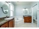 Bright bathroom featuring a garden tub, dual vanities, and tile flooring at 1813 Sw 157Th Place Rd, Ocala, FL 34473
