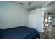 Bedroom with a ceiling fan and view into a living area, with wood-look flooring at 1813 Sw 157Th Place Rd, Ocala, FL 34473