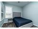 Comfortable bedroom featuring a neutral color scheme, and a window with plantation shutters at 1813 Sw 157Th Place Rd, Ocala, FL 34473