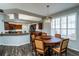 Cozy dining area with a round table, wood floors, and abundant natural light through plantation shutters at 1813 Sw 157Th Place Rd, Ocala, FL 34473