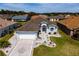 Aerial view of a beautiful home featuring manicured landscaping and a three-car garage with ample parking space at 1813 Sw 157Th Place Rd, Ocala, FL 34473