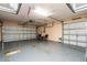 A spacious three car garage with overhead lighting and two chairs is ready for parking and storage at 1813 Sw 157Th Place Rd, Ocala, FL 34473