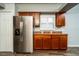 Spacious kitchen showcasing stainless steel refrigerator, ample cabinet space, and modern flooring at 1813 Sw 157Th Place Rd, Ocala, FL 34473