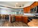 Kitchen featuring wood cabinets, stainless steel appliances, and an open layout to the dining area at 1813 Sw 157Th Place Rd, Ocala, FL 34473