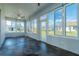 Enclosed lanai with decorative tile flooring, fan, and walls of windows provides outdoor views and access to the backyard at 1813 Sw 157Th Place Rd, Ocala, FL 34473