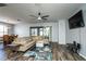 Comfortable living room featuring wood floors, a sectional sofa, and a ceiling fan for a relaxing atmosphere at 1813 Sw 157Th Place Rd, Ocala, FL 34473