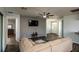 Open-concept living area with wood flooring, a large TV, and an inviting sofa for relaxation at 1813 Sw 157Th Place Rd, Ocala, FL 34473