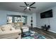 Bright living room featuring a sectional sofa, modern rug, and sliding glass doors to the outdoor area at 1813 Sw 157Th Place Rd, Ocala, FL 34473