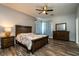 Comfortable main bedroom featuring a wooden bed frame, ceiling fan, and wood-look flooring at 1813 Sw 157Th Place Rd, Ocala, FL 34473