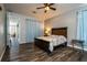 Spacious main bedroom with wood-look flooring, a ceiling fan, and ample natural light at 1813 Sw 157Th Place Rd, Ocala, FL 34473